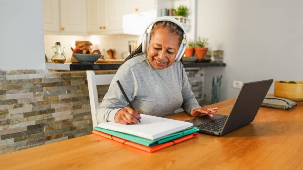 Senior african woman doing digital class webinar from home